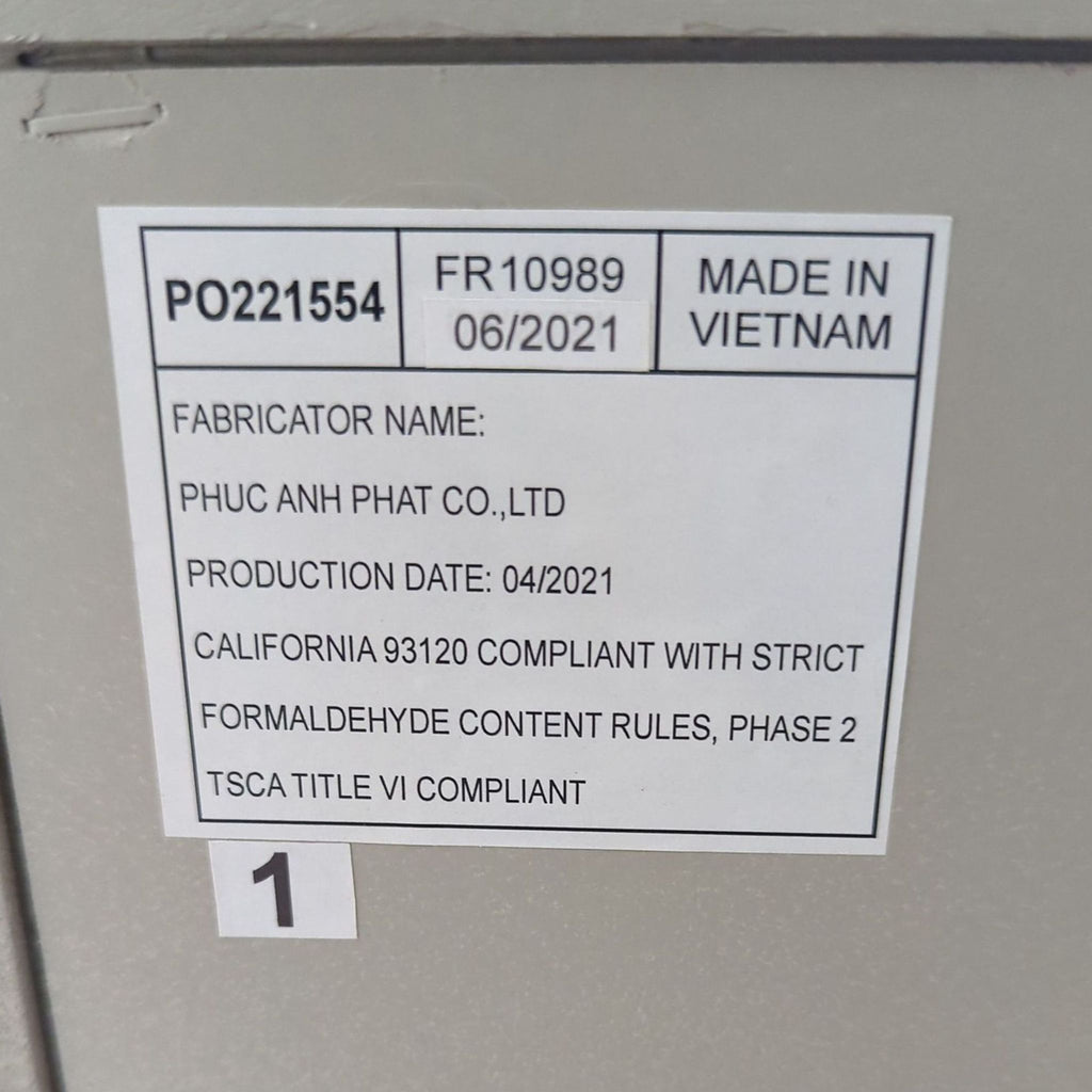 3. Close-up of product label indicating the Reperch table was made in Vietnam, produced in 2021, and compliant with safety standards.