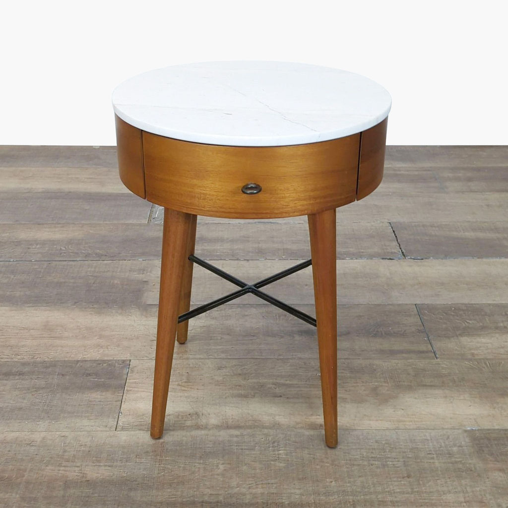 1. West Elm round end table with white marble top, wooden base, single drawer, and slender legs on wood floor.