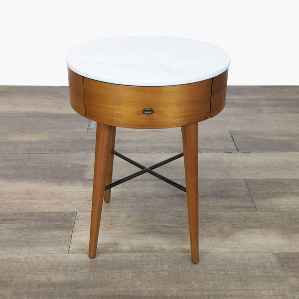 1. West Elm round end table with white marble top, wooden base, single drawer, and slender legs on wood floor.