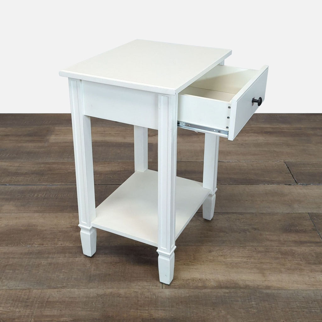 2. Angle view of a Reperch white console table with its drawer open and a lower shelf for storage.