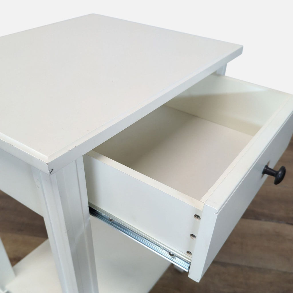 3. Close-up of the Reperch side table highlighting the open drawer and clean white tabletop.