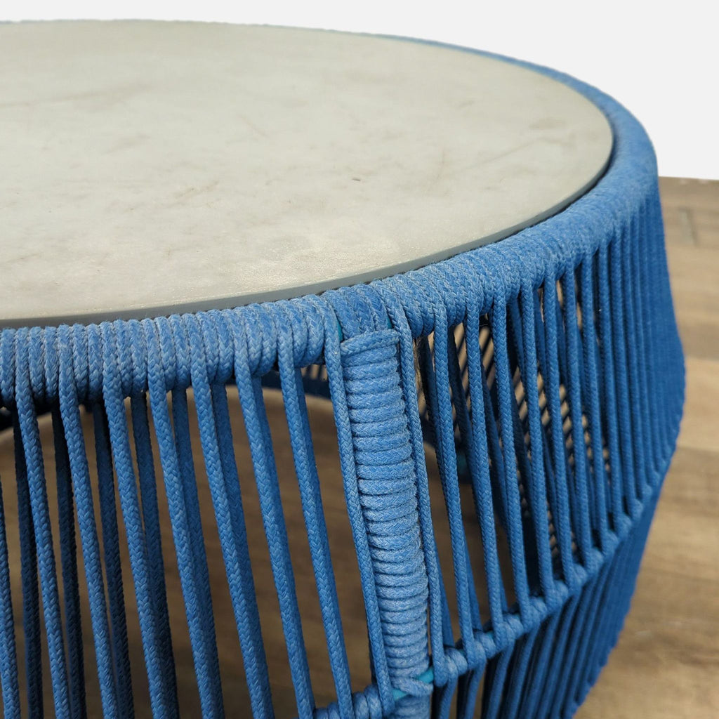 Close-up of Reperch table’s blue rope weaving and stone top, highlighting its unique craftsmanship.