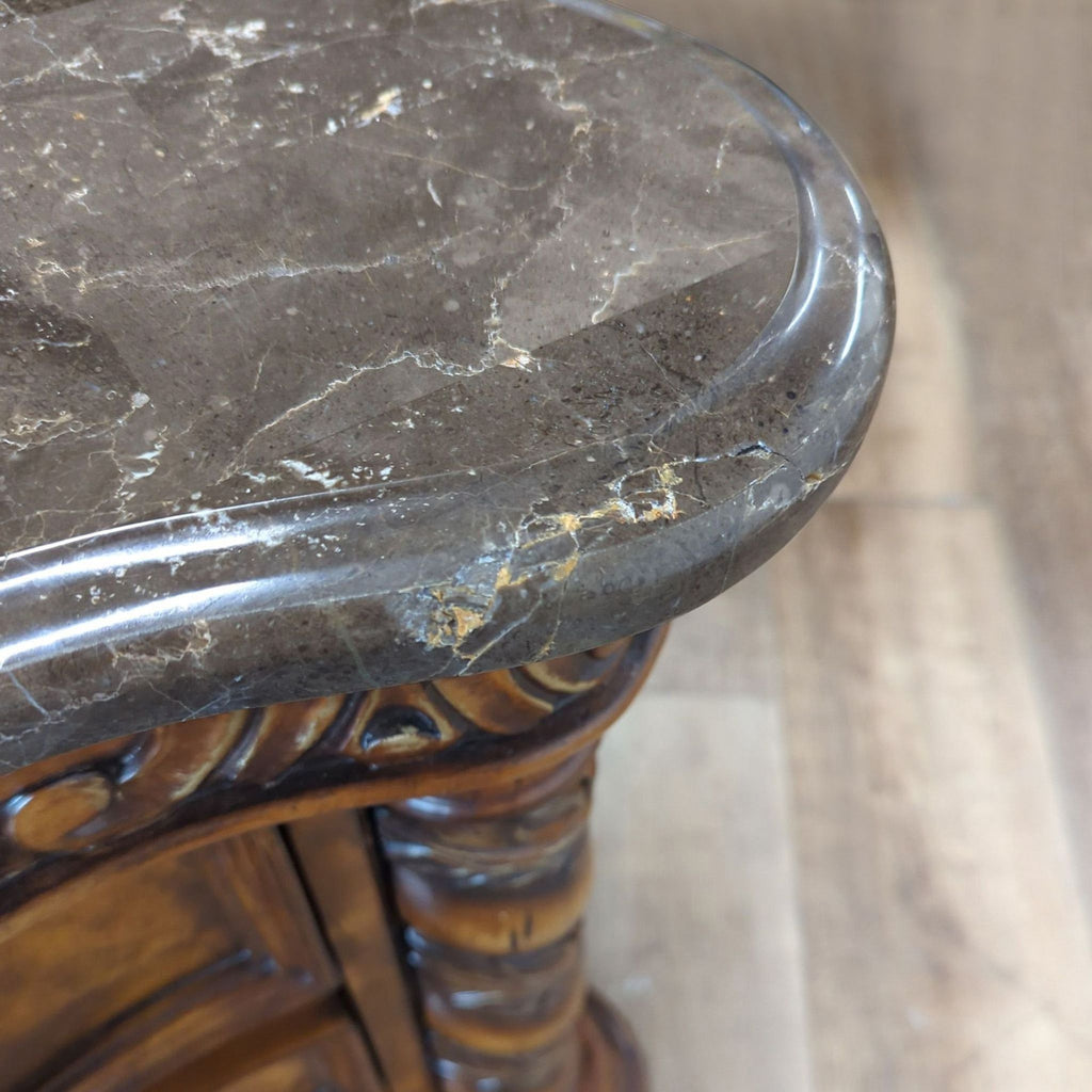 3. Close-up of the Reperch end table’s polished marble top, displaying its natural veining and beveled edge.