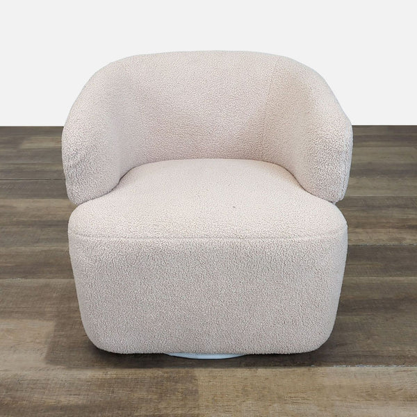 Front view of Amazon lounge chair with cream Sherpa upholstery and a 360-degree swivel base.  