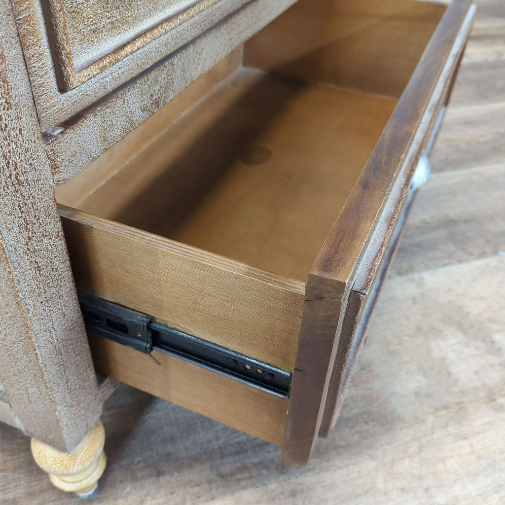 3. Close-up of an open drawer on a Pottery Barn dresser, detailing spacious interior and slide mechanism.