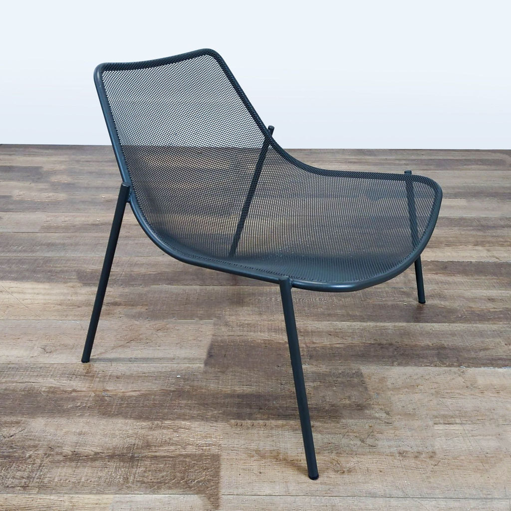 - Angled side view of the airy Reperch chair, showing its distinctive curved shape and mesh construction.