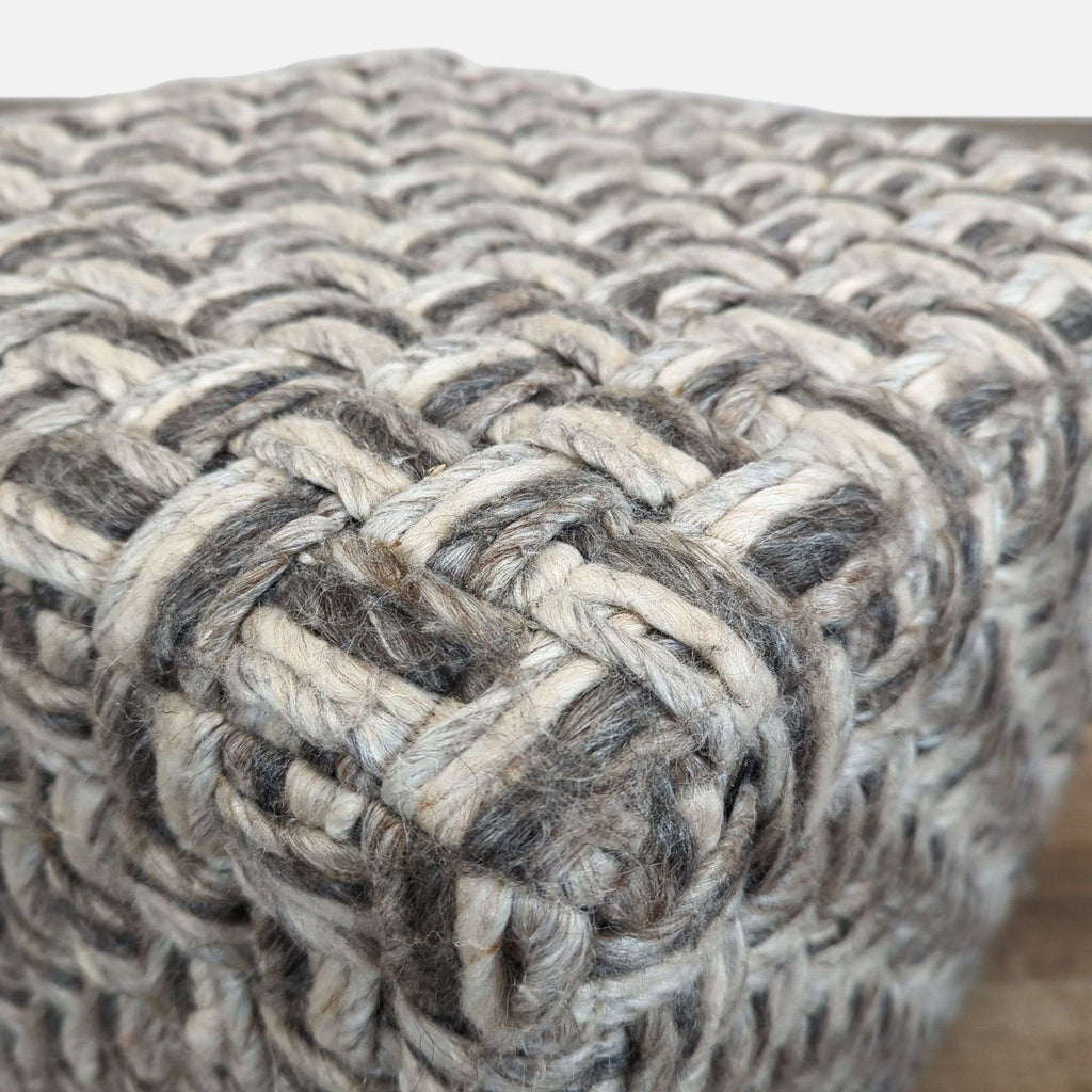 2. Close-up of Surya ottoman showing detailed wool-polyester overstitching in gradient neutral shades.  