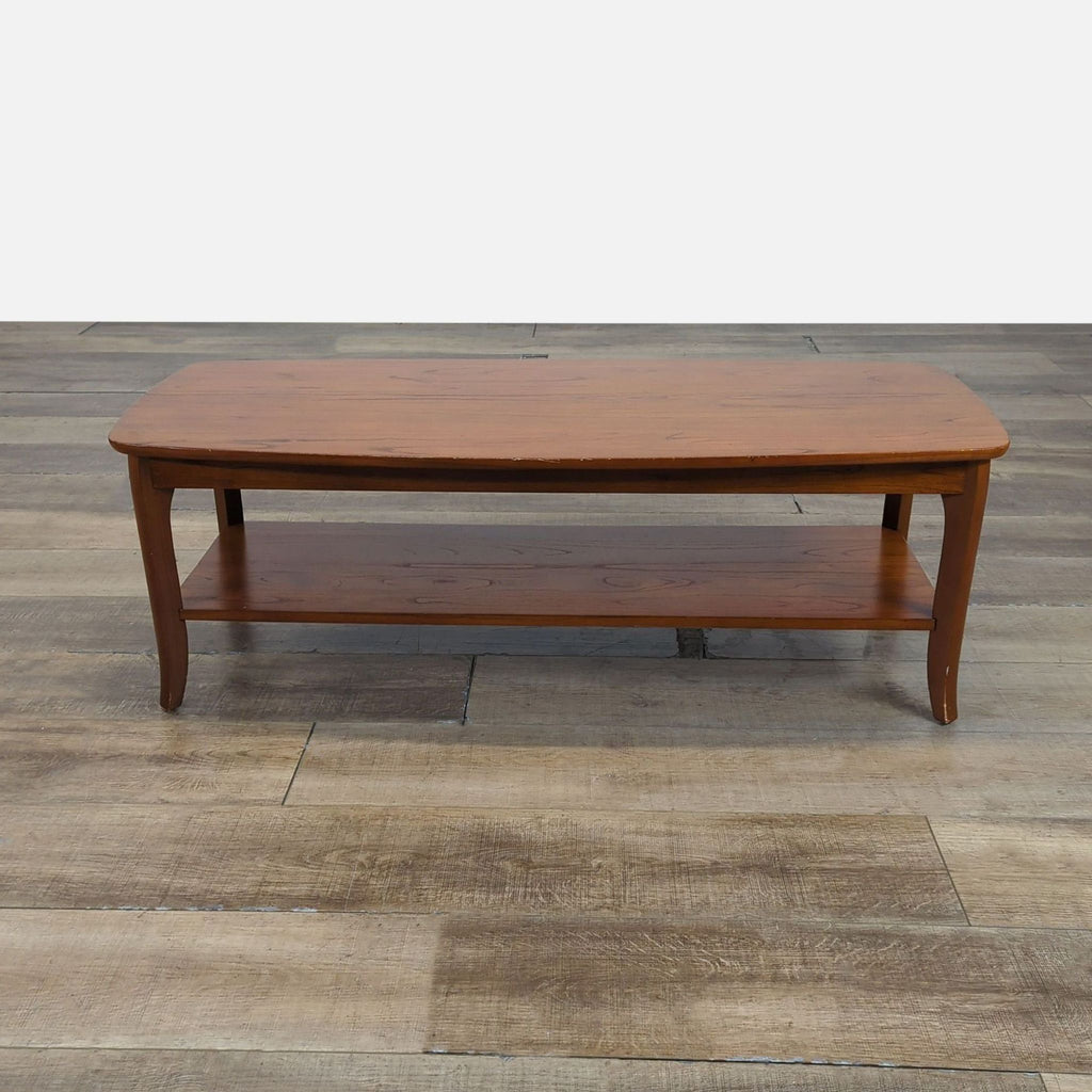 1. Pottery Barn coffee table with rounded corners, gently flared legs, and a lower shelf on wood flooring.