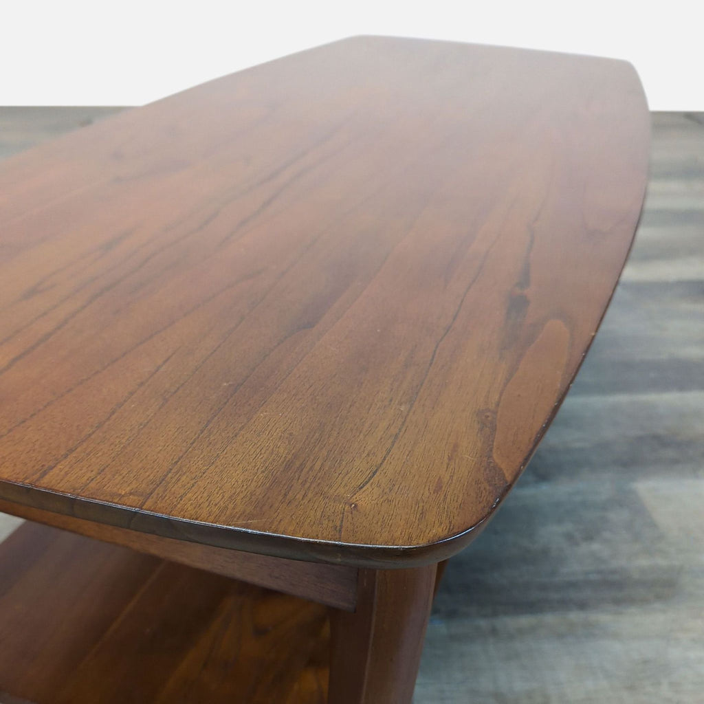 3. Close-up of the Pottery Barn coffee table showcasing its rounded wooden corner and grain texture.