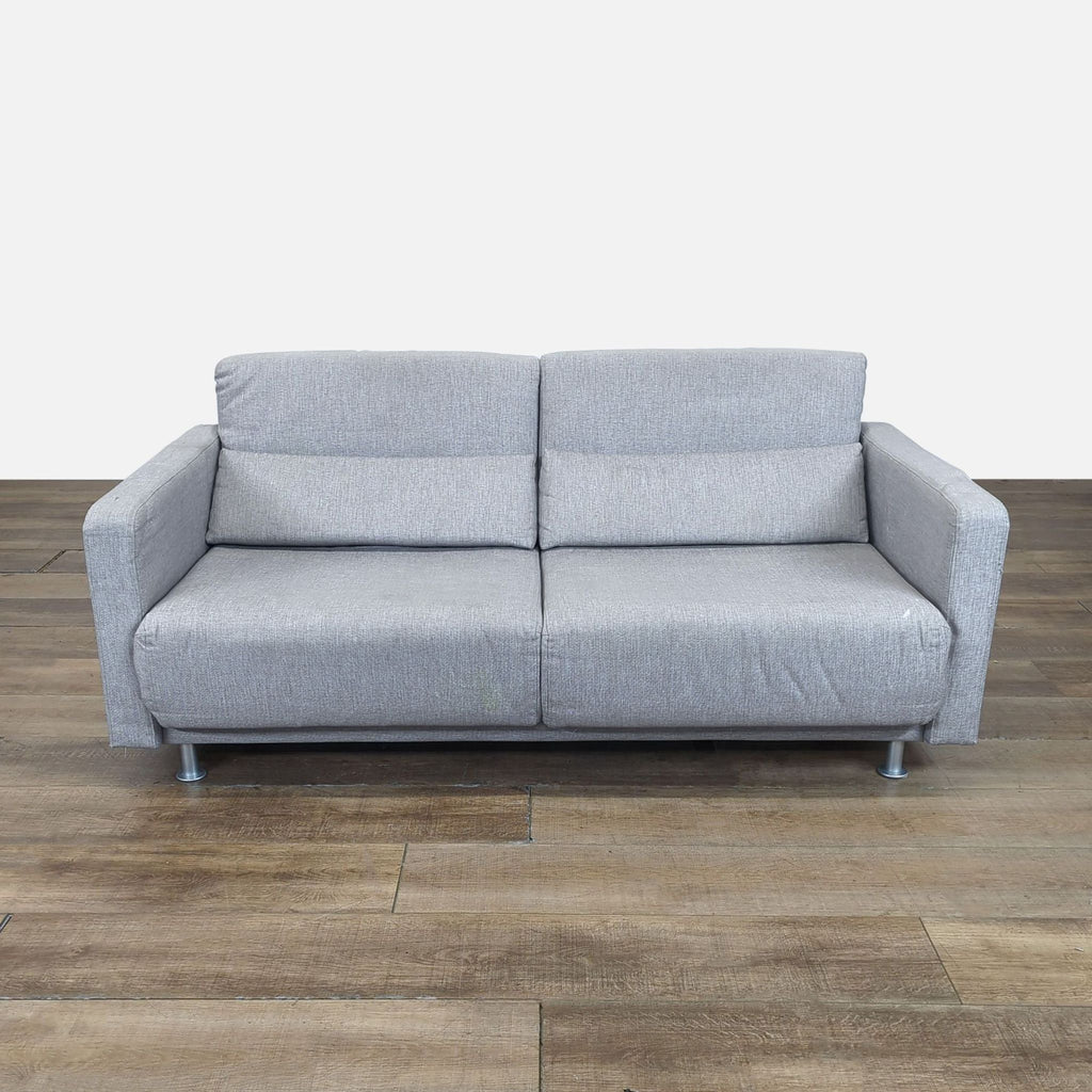1. Gray Bo Concept loveseat sofa with metal legs, shown upright on wooden floor, modern style.