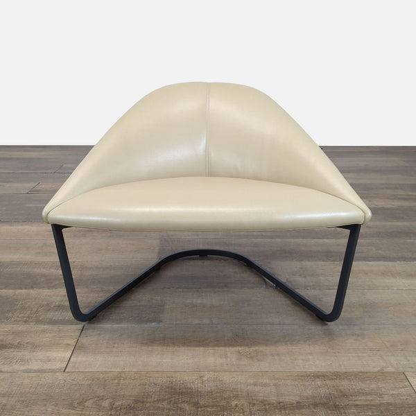 1. Lounge chair by Arper with a curved beige seat and back, featuring a sleek black metal sled base.