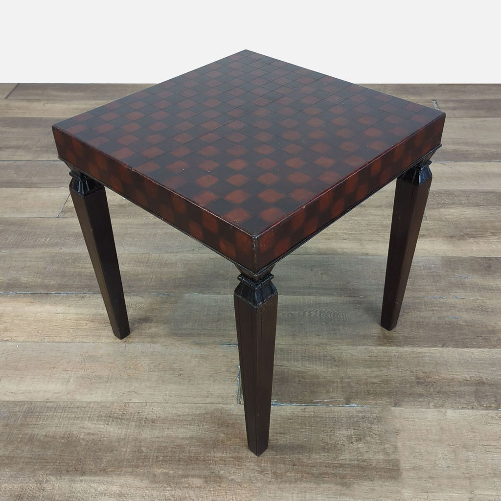 3. Angled view of a South Cone end table featuring a dark checkerboard top and sturdy, carved wooden legs.