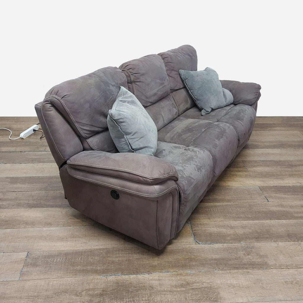 3. Angled view of Reperch 3-seat sofa, highlighting soft cushions and two power reclining seats, with pillows.