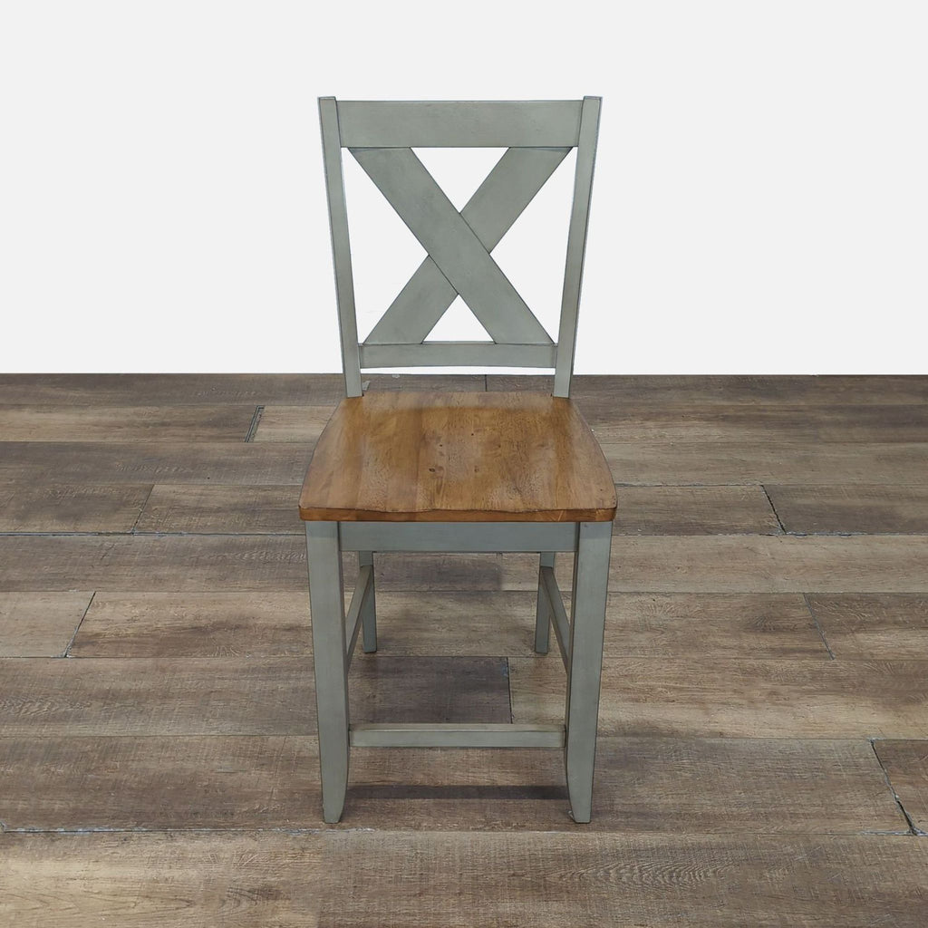 1. Wooden stool by Winners Only, Inc. with an X-back design and natural wood seat, shown on a rustic floor.