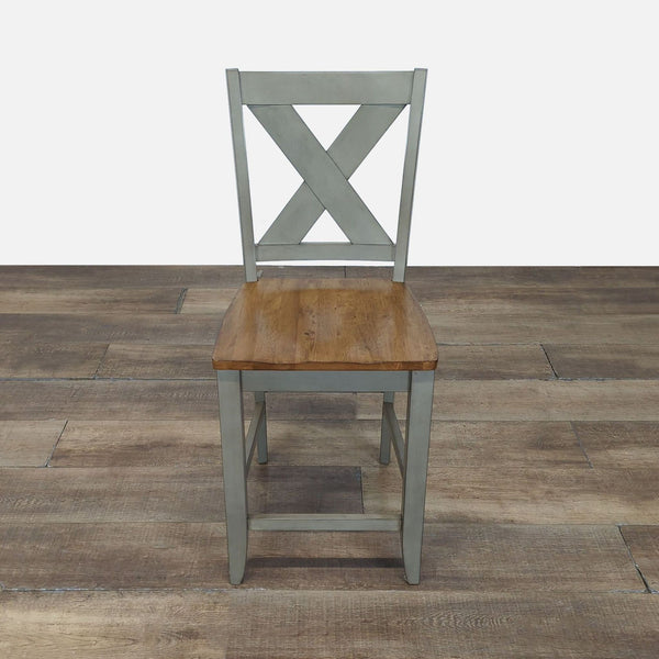 1. Wooden stool by Winners Only, Inc. with an X-back design and natural wood seat, shown on a rustic floor.