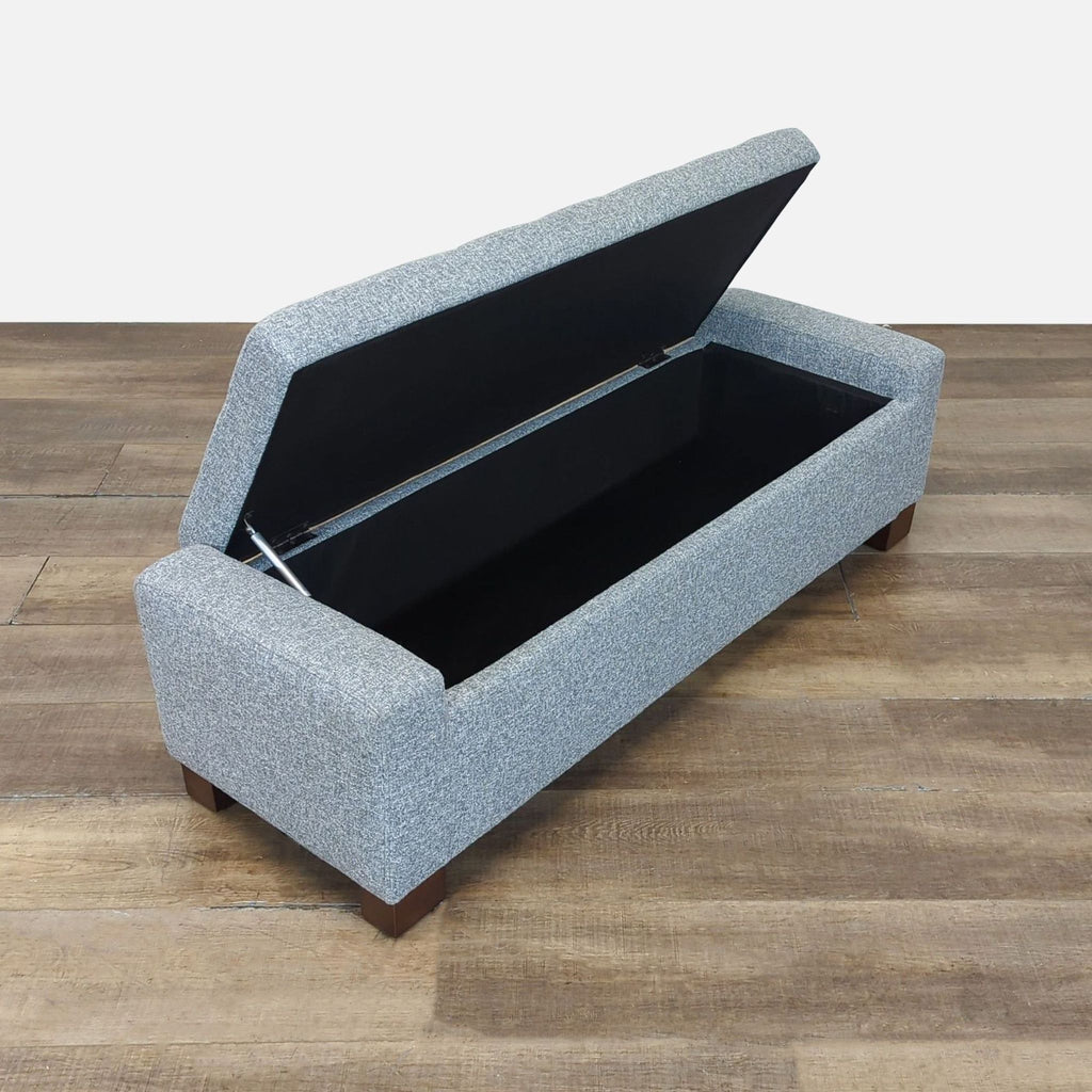 2. Grey Reperch storage ottoman bench with open hinged lid, displaying ample inner compartment for storage.