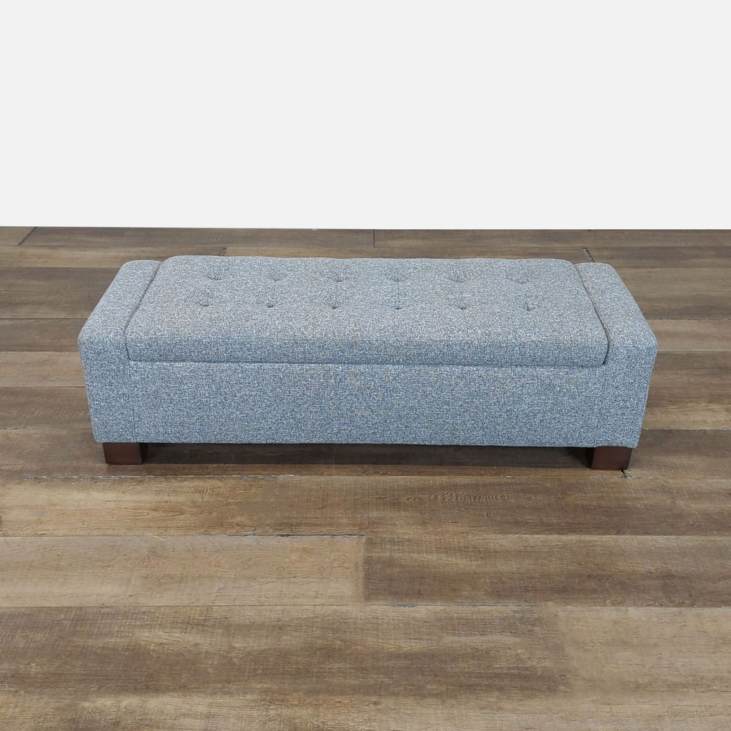 1. Rectangular Reperch upholstered bench ottoman with button-tufted top on wooden legs, shown on wood flooring.