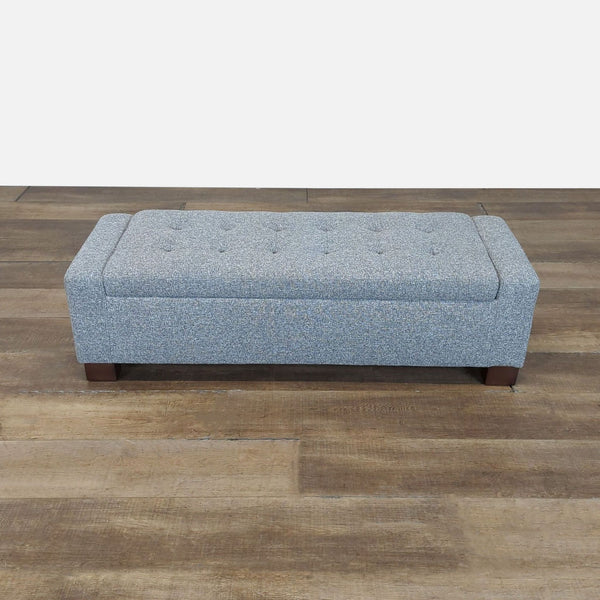 1. Rectangular Reperch upholstered bench ottoman with button-tufted top on wooden legs, shown on wood flooring.