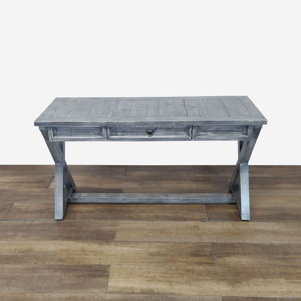 1. Grey Reperch side and console table with single center drawer and cross-leg design, on wood floor.