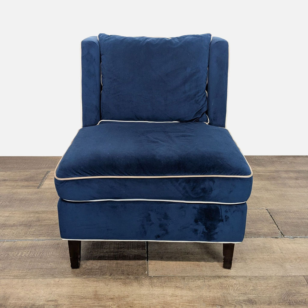 1. Front view of a Reperch lounge chair with navy blue velvet upholstery and white piping details.  
