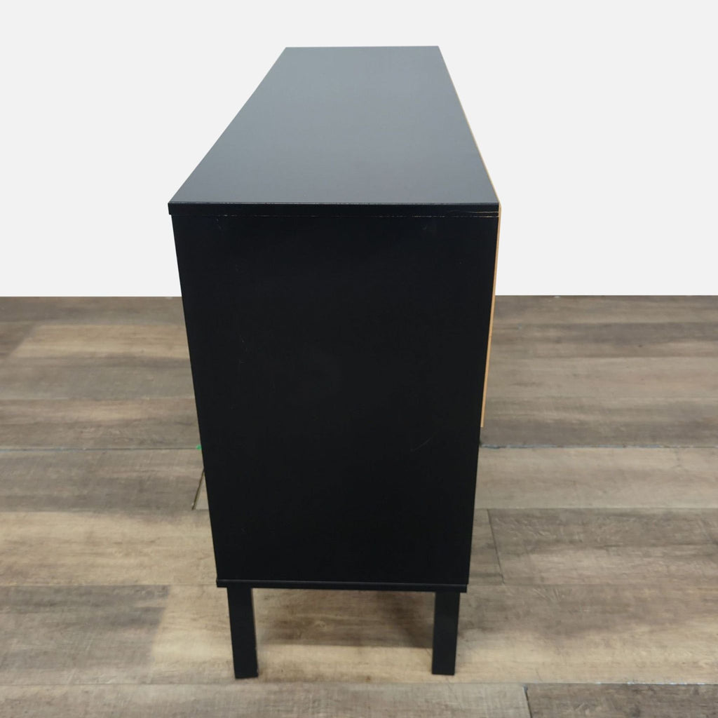 3. Side profile of Prepac mid-century modern black dresser with clean, rectangular lines and tall legs.