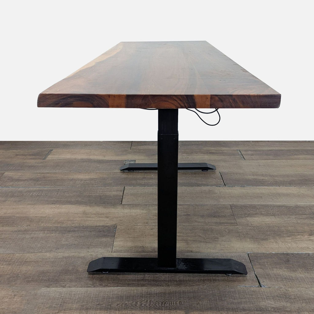 2. Side view of a Reperch solid wood desk featuring adjustable height and black metal legs.
