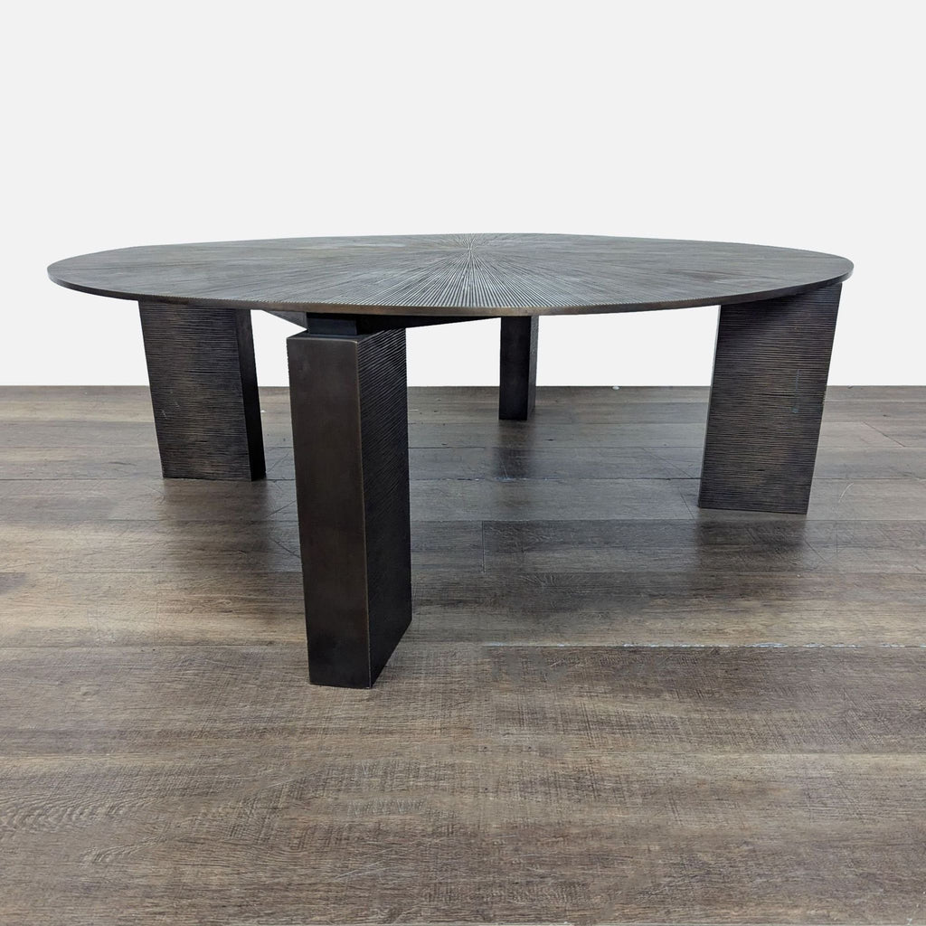 2. Side view of a Reperch coffee table showing its thick round top with unique radial grooves and three legs.