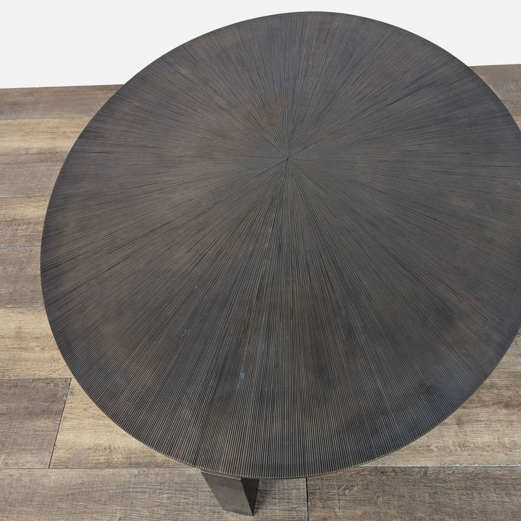 3. Overhead view of the Reperch coffee table, highlighting its circular grooved surface and modern design.