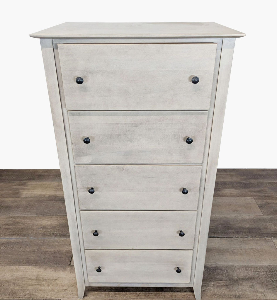 1. Light wood dresser with a glazed finish, featuring five drawers and black knobs, by Stuart David.