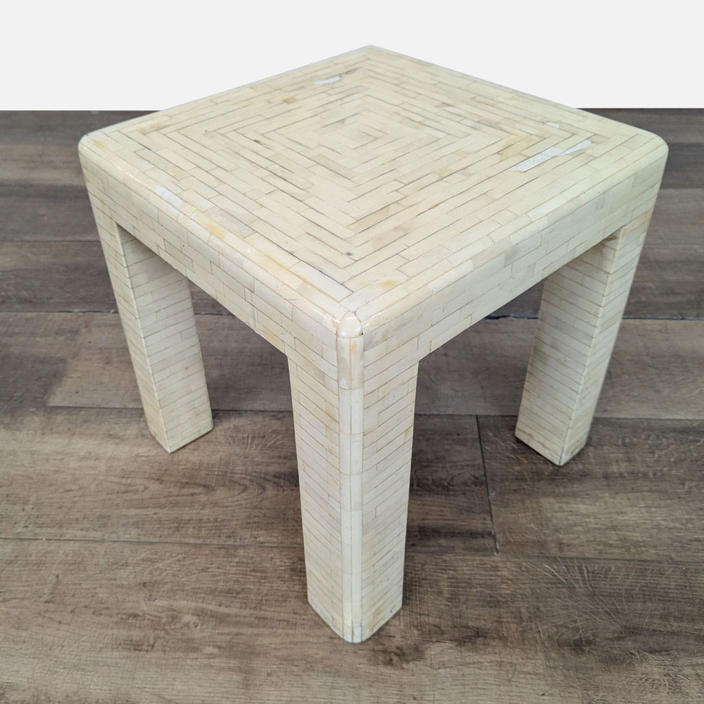 1. Square Reperch side table with ivory geometric inlay pattern, shown on a wood floor from an angled view.  