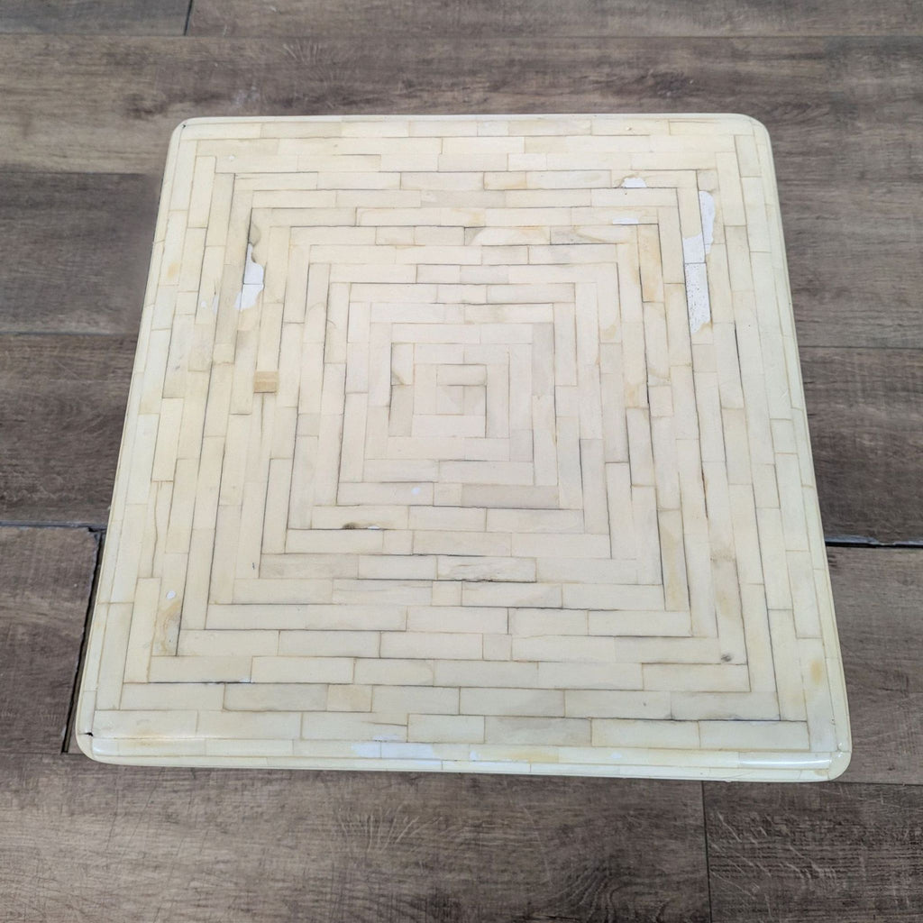 3. Overhead image of a Reperch side table highlighting its square top with ivory tile details and subtle texture.