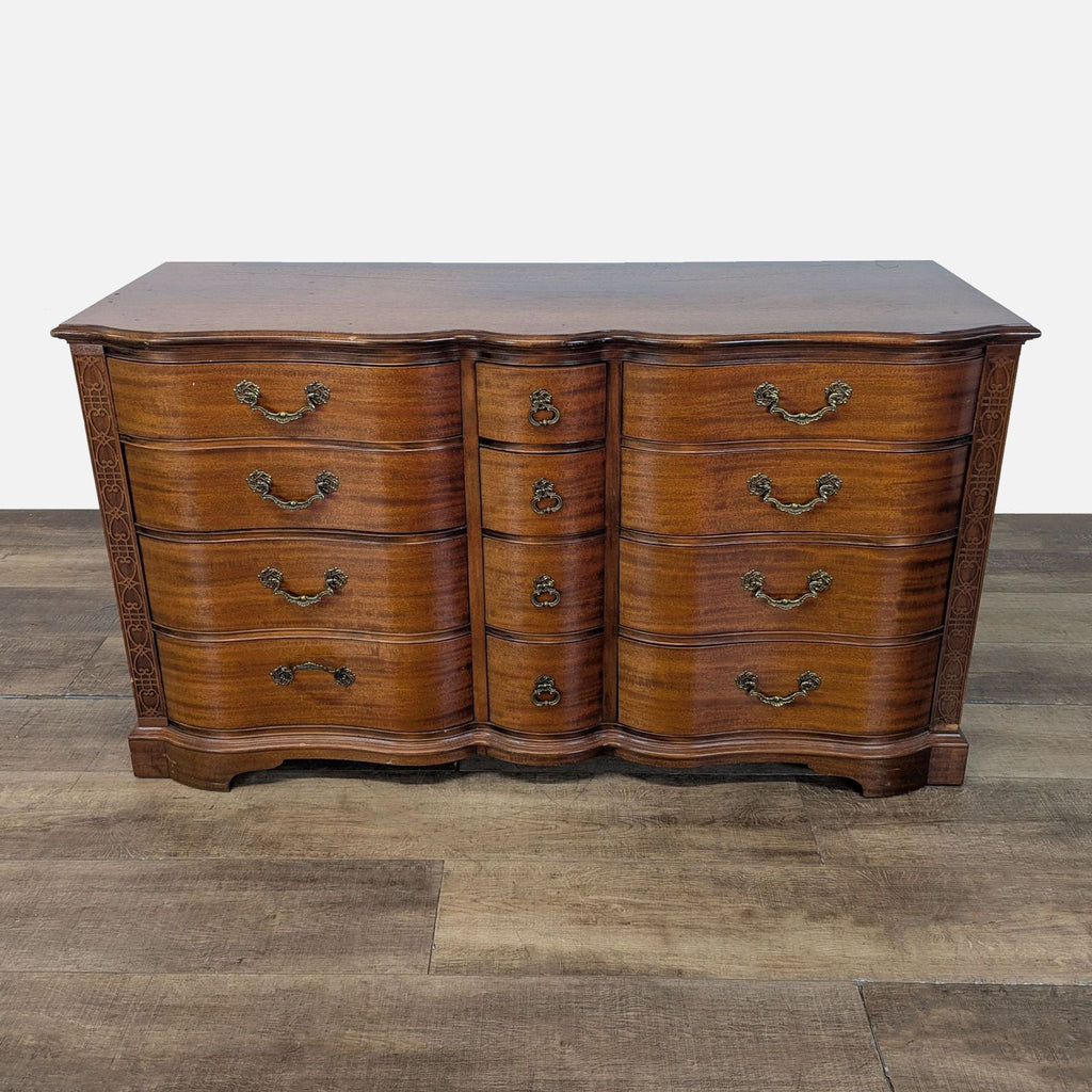 1. Reperch dresser with serpentine front, brass handles, and ornate trim, shown from the front on wood floor.