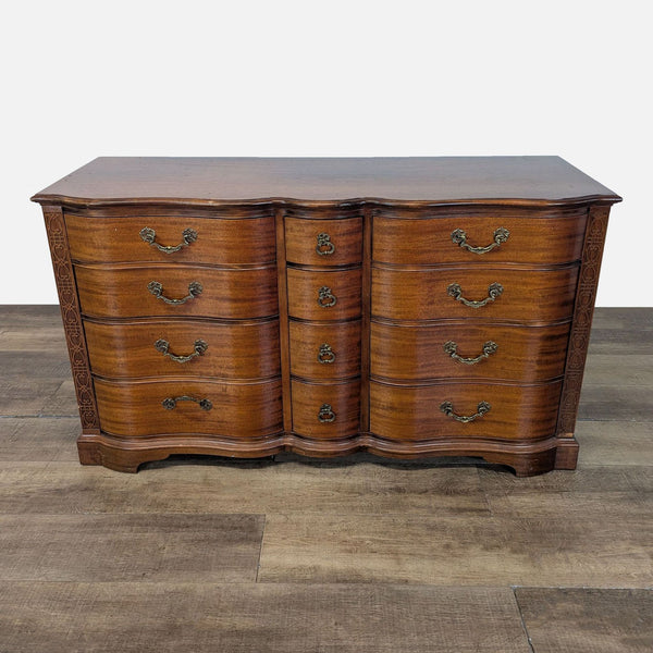 1. Reperch dresser with serpentine front, brass handles, and ornate trim, shown from the front on wood floor.