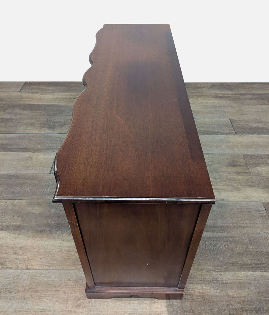 3. Top-down view showing the wavy serpentine edge and smooth wood surface of the Reperch dresser.