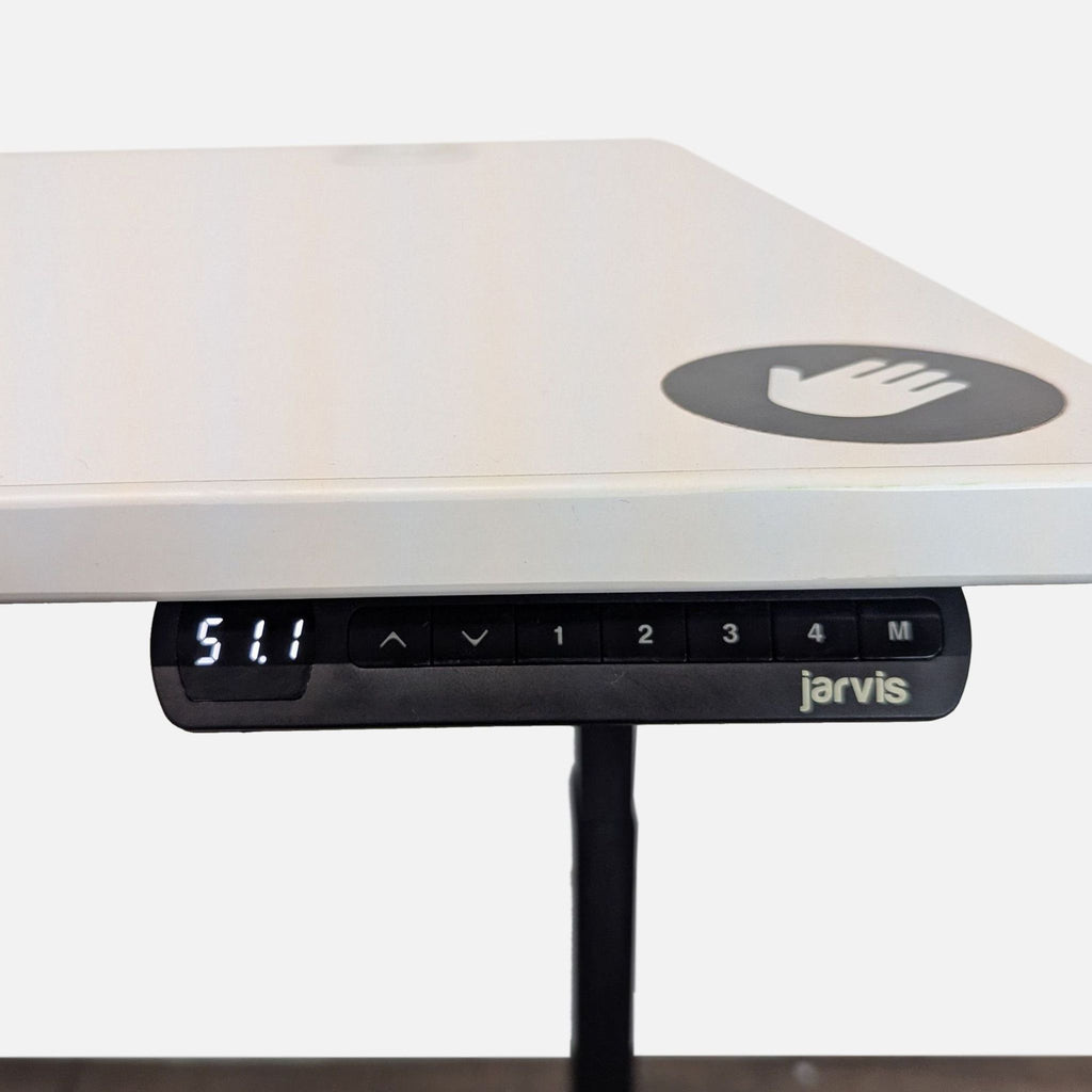 2. Close-up of Jarvis desk programmable control panel with height display and brand logo.