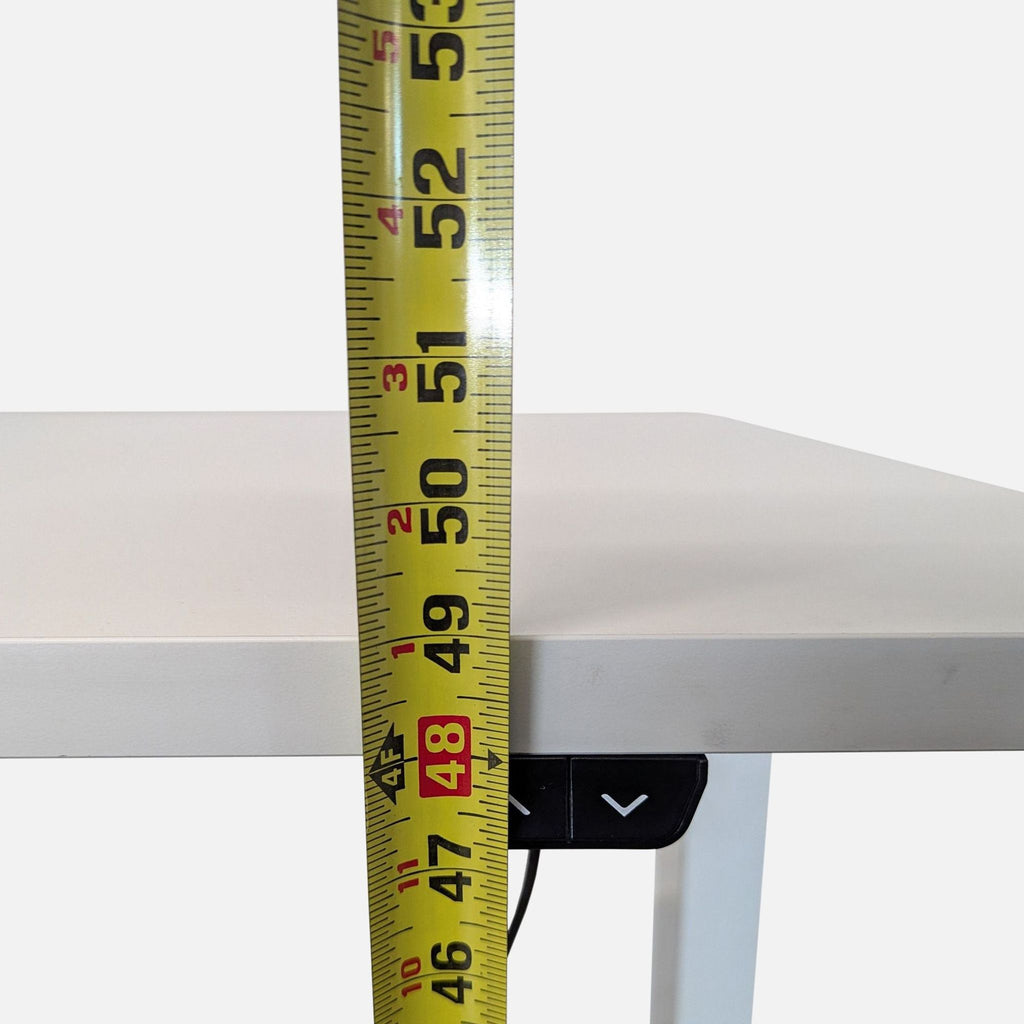 2. Close-up of Reperch standing desk controller, showing a tape measure for height adjustment detail.  
