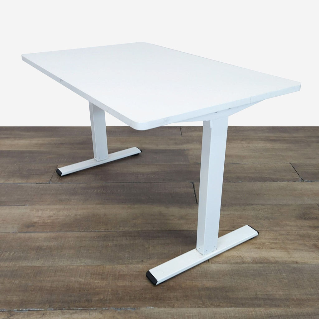 3. Angled view of Reperch adjustable standing desk with white tabletop and sturdy metal legs.