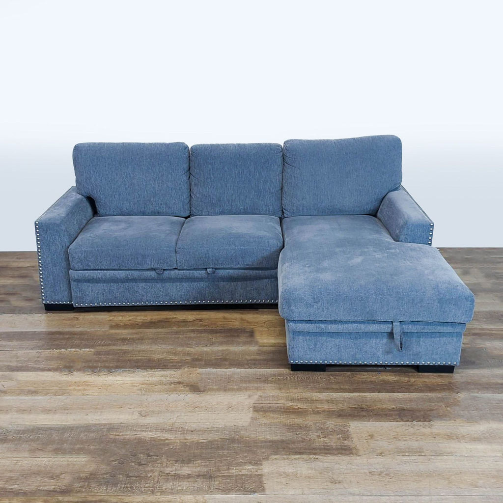 1. Reperch blue chenille sleeper sofa with modern track arms, nailhead trim, and storage chaise, front view.