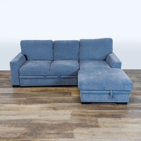 1. Reperch blue chenille sleeper sofa with modern track arms, nailhead trim, and storage chaise, front view.