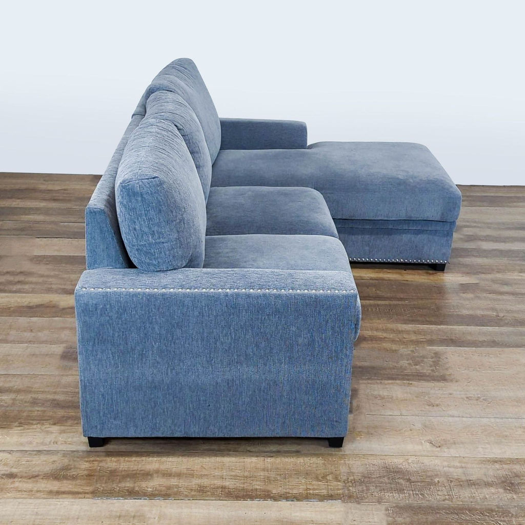 3. Side view of Reperch sleeper sofa showing track arms, loose back cushions, and left-facing storage chaise.