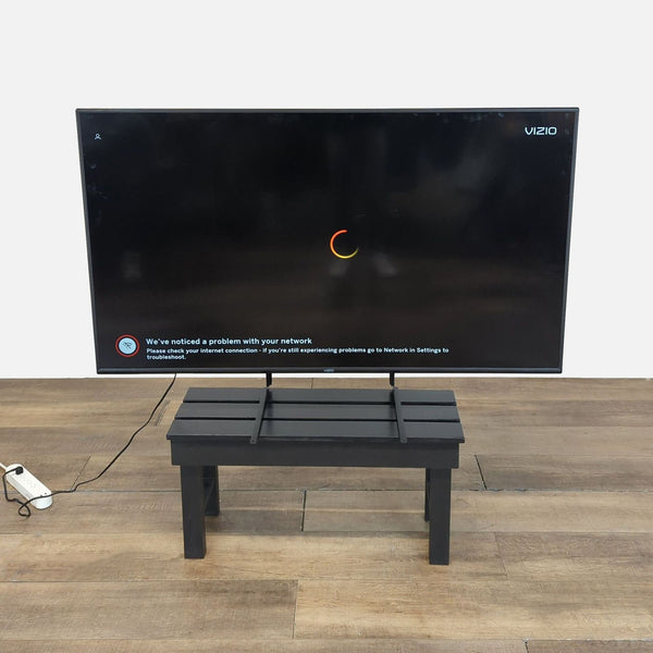 Vizio 43-inch Smart LED TV displayed on a small black table, screen showing network error message.