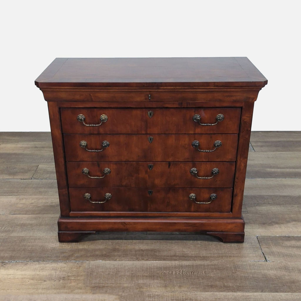 Mahogany Henredon dresser with brass drop pulls and keyholes, shown closed on a wood floor.  