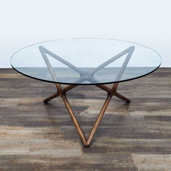 1. Round dining table with geometric American ash base in walnut finish and clear tempered glass top by Nuevo.