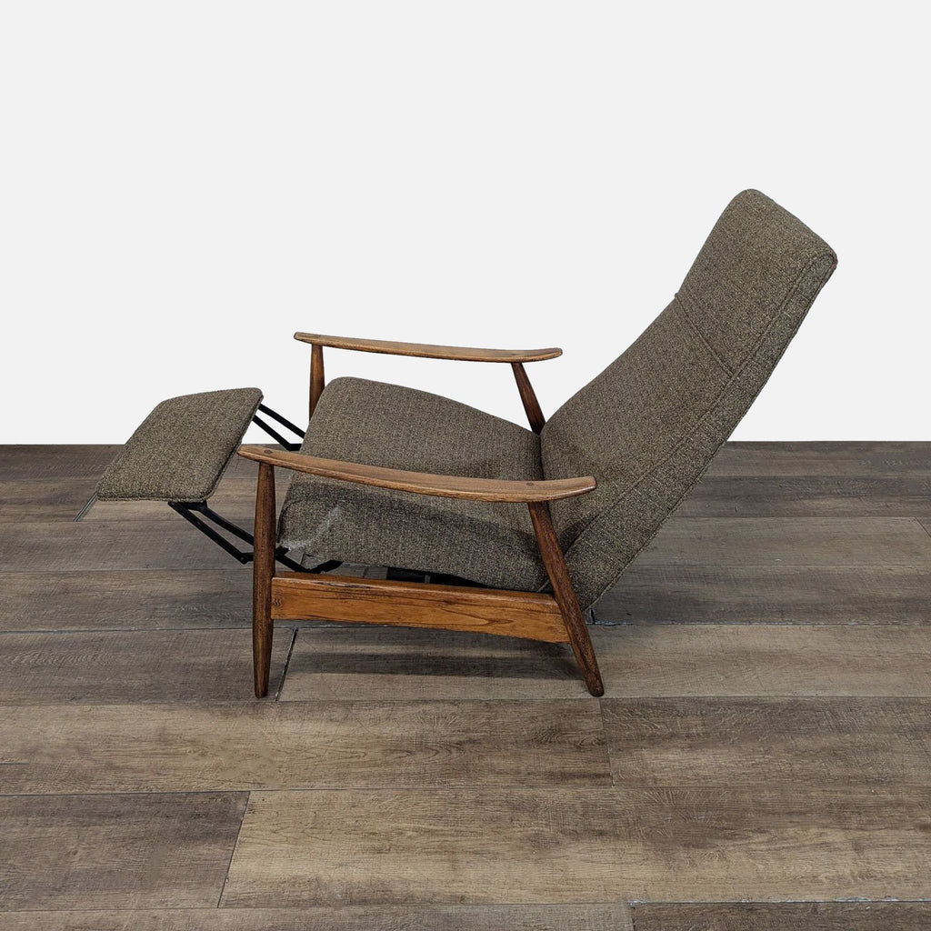 2. Side view of a Milo Baughman lounge chair in reclined position, showing extended footrest and wood arms.