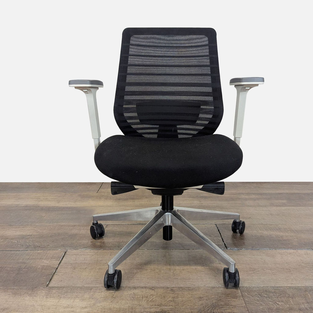 1. Front view of Bureau chair featuring 3D armrests, mesh back, and cushioned seat on a wheeled base.