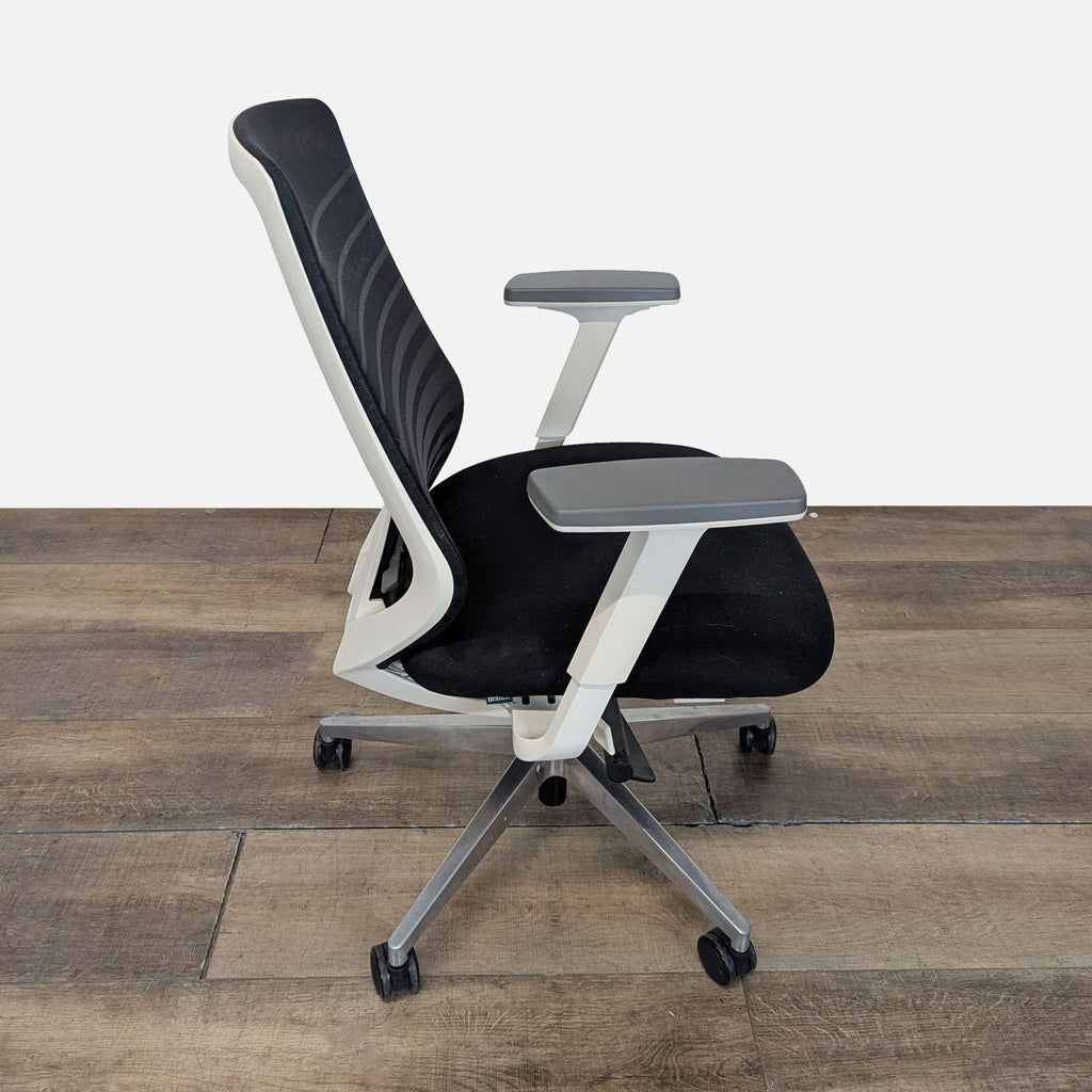 2. Side profile of Bureau ergonomic chair showing height-adjustable armrests and mesh back support.