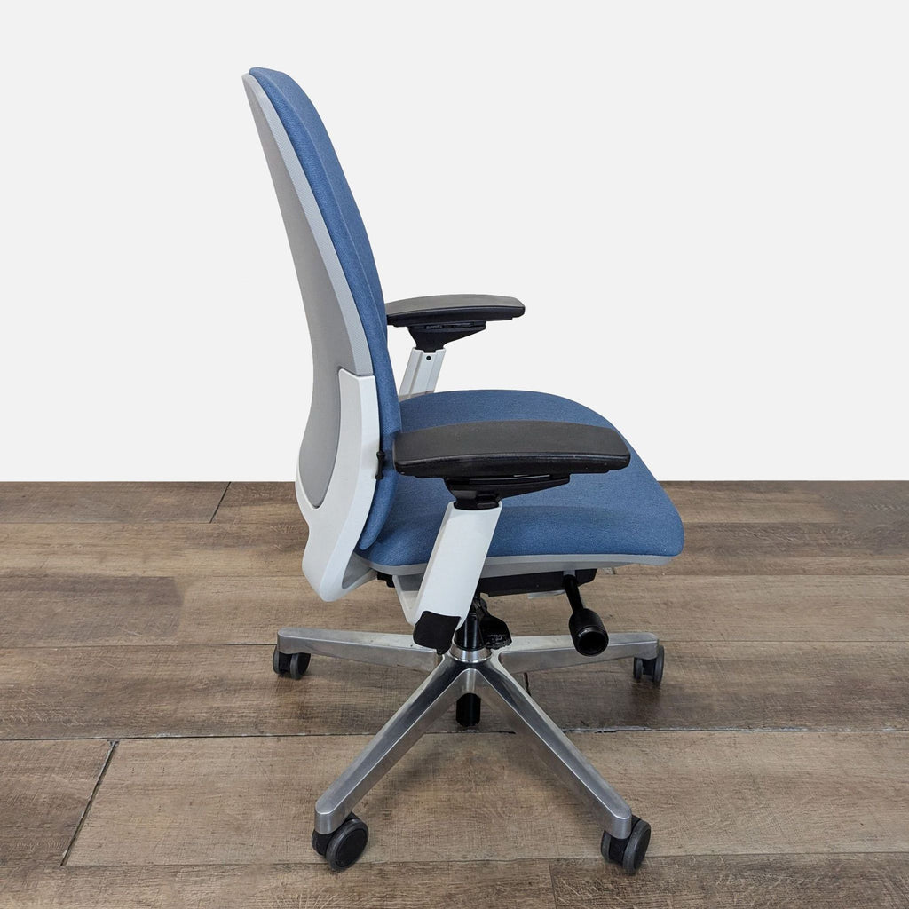 2. Side view showing the adjustable features and contoured back of a Steelcase ergonomic office chair.