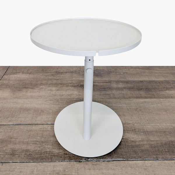 1. Modern round white Reperch side table with a central pedestal base, standing on a wooden floor.  