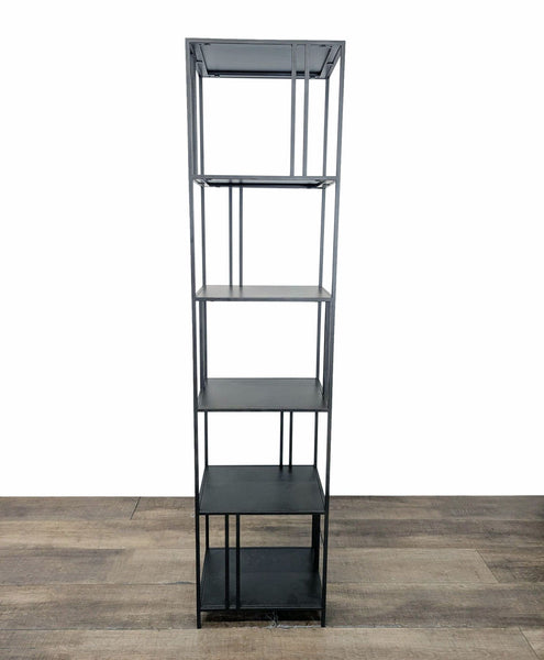 1. Minimalist West Elm bookshelf with slim metal frame and staggered shelves, shown on wooden floor.