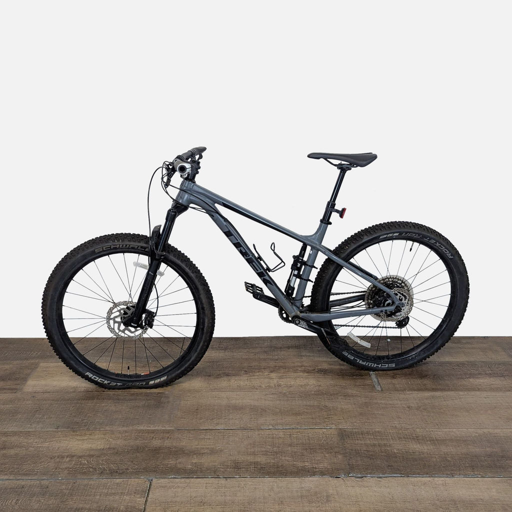1. Grey Trek full suspension mountain bike with disc brakes and knobby tires, ideal for trail and outdoor riding.